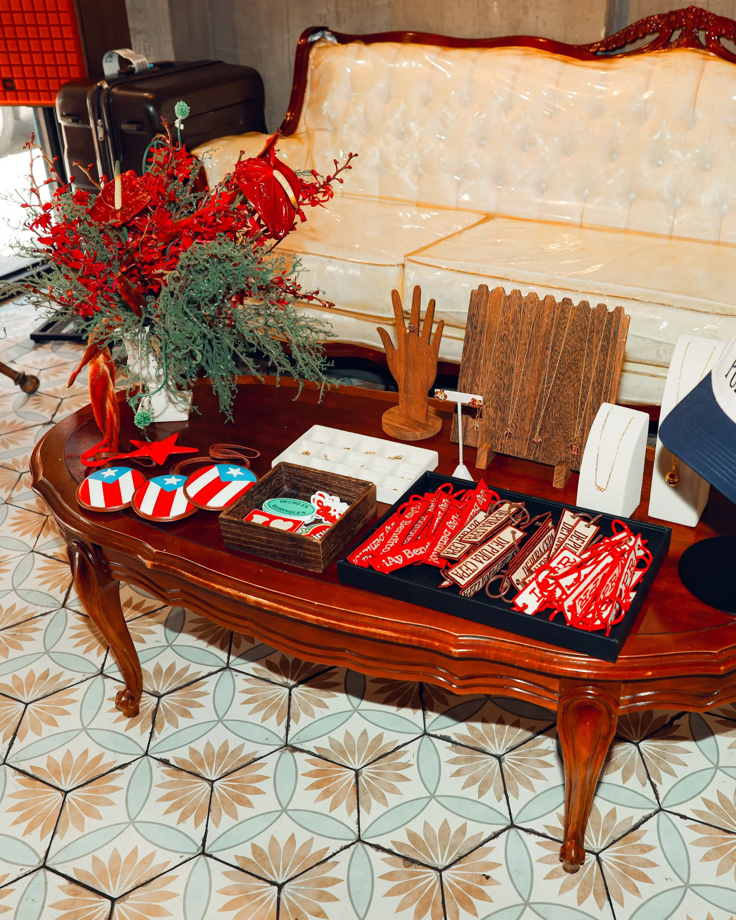 Vintage coffee table displaying jewelry, coasters, and small gifts at an indoor celebration